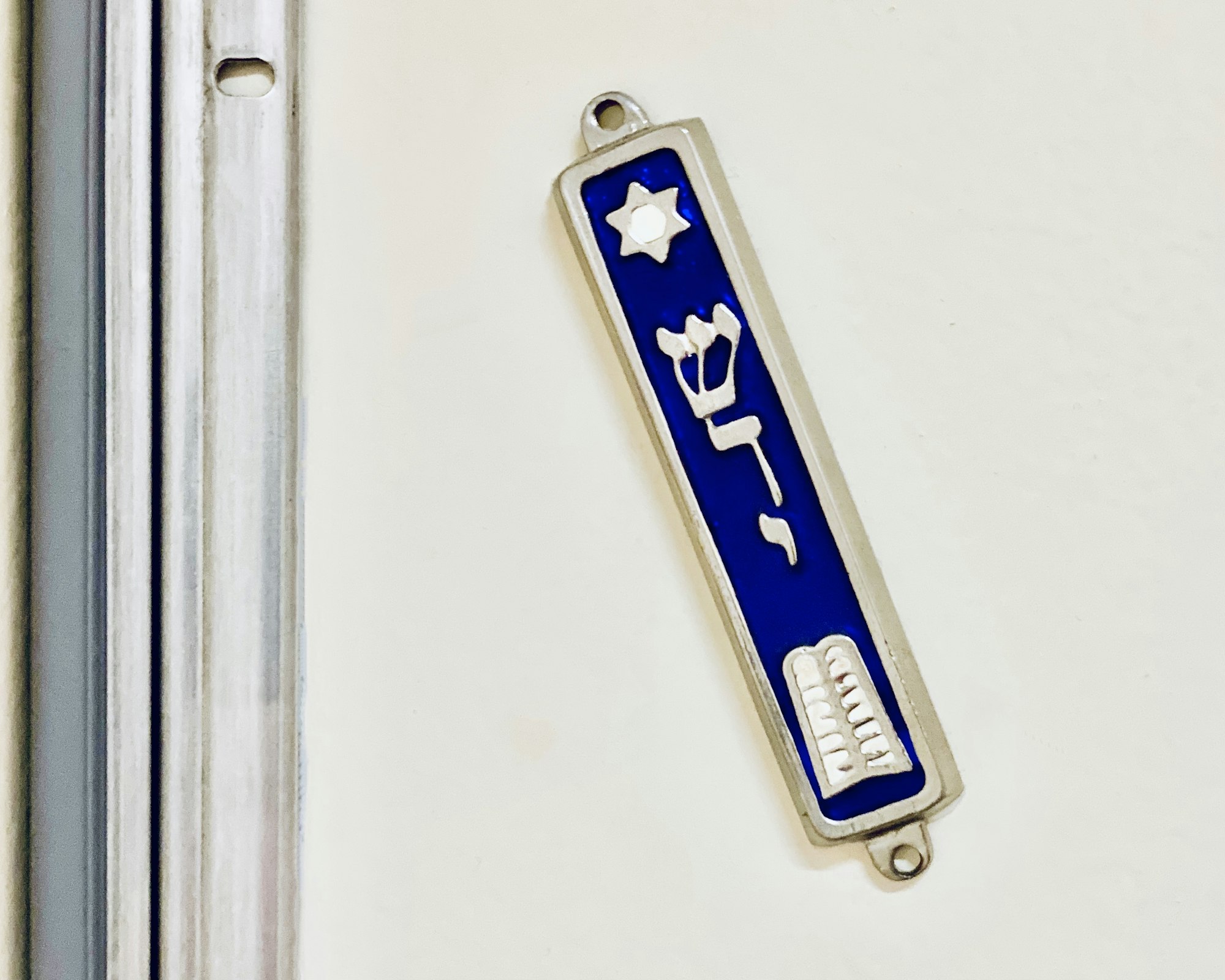 10 Commandments Mezuzah that was made in Israel, hanging in the doorpost of an apartment entrance