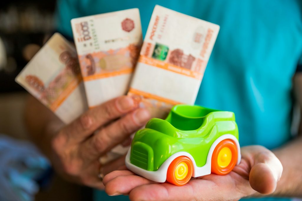 car and money in male hands, car loan concept, Saving money for car concept, trade car for cash